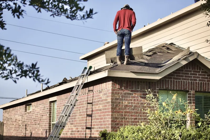 Professional roofer working on a residential roof in Brownstown Estates